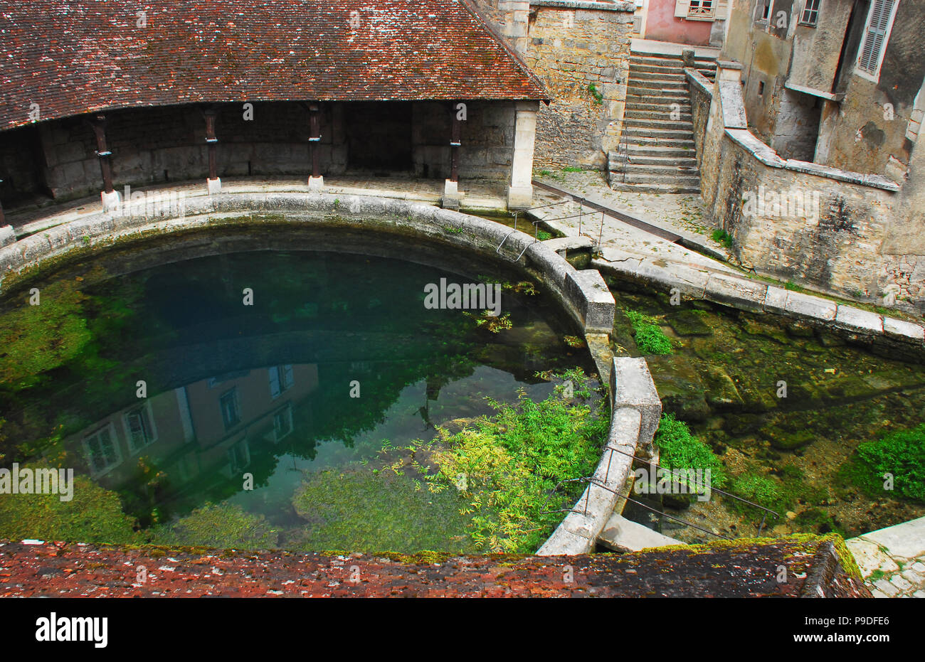 The Fosse Dionne is the source of the Vaucluse spring and is dedicated to the ancient Goddess Divona. . . which means divine.. A circular wash basin a Stock Photo