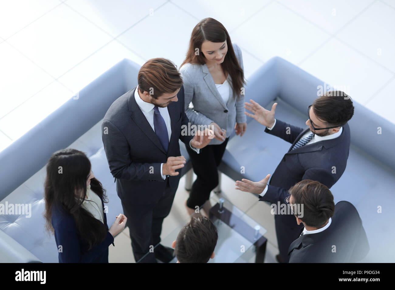 Happy smiling business team standing in a row at office Stock Photo - Alamy