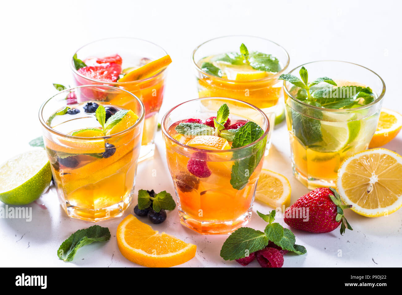 Summer drink assortment. Lemonade, mojito and berry lemonade in glasses
