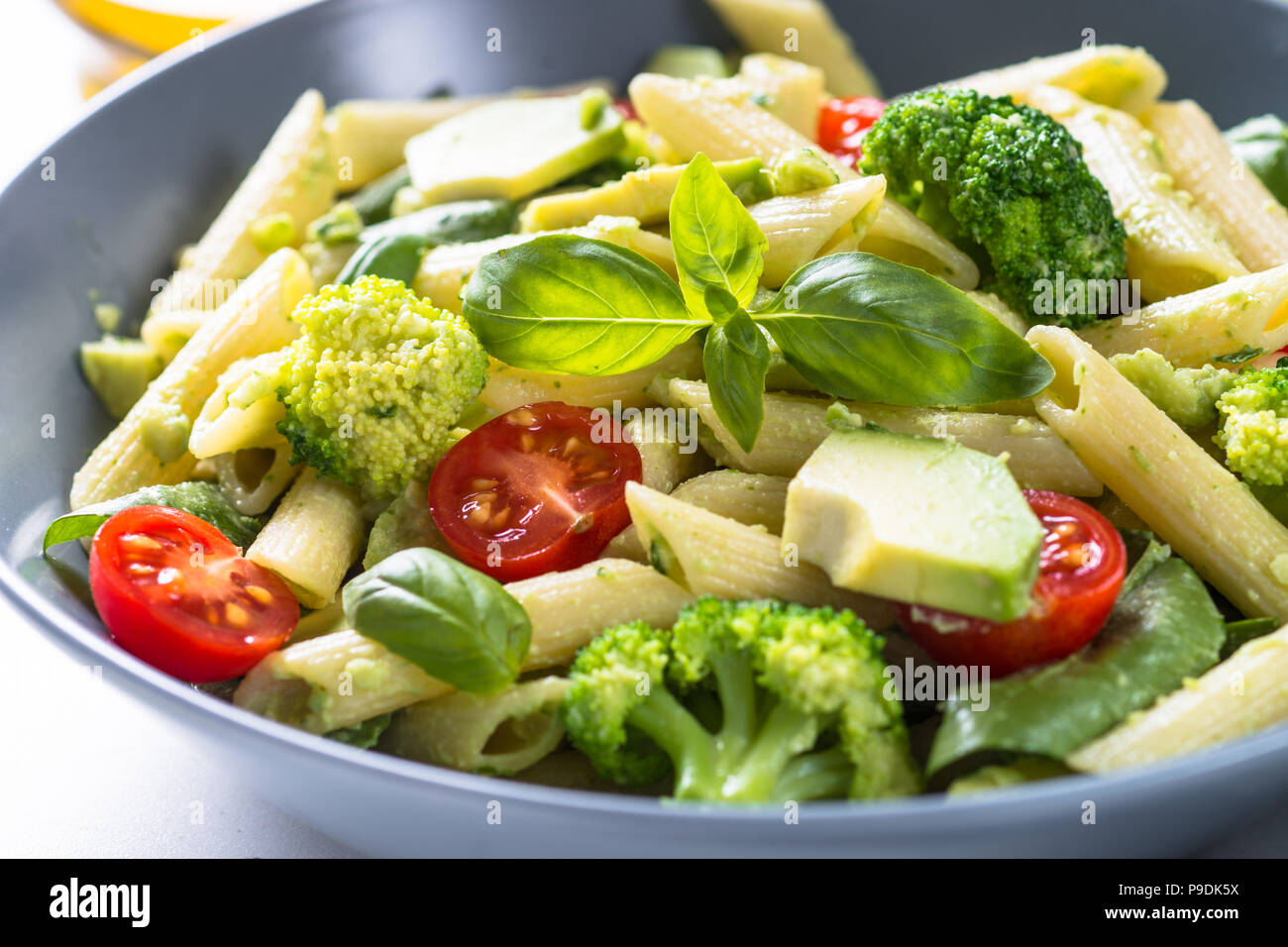 Vegetarian Pasta Penne With Avocado Broccoli Tomato Spinach And Basil Stock Photo Alamy