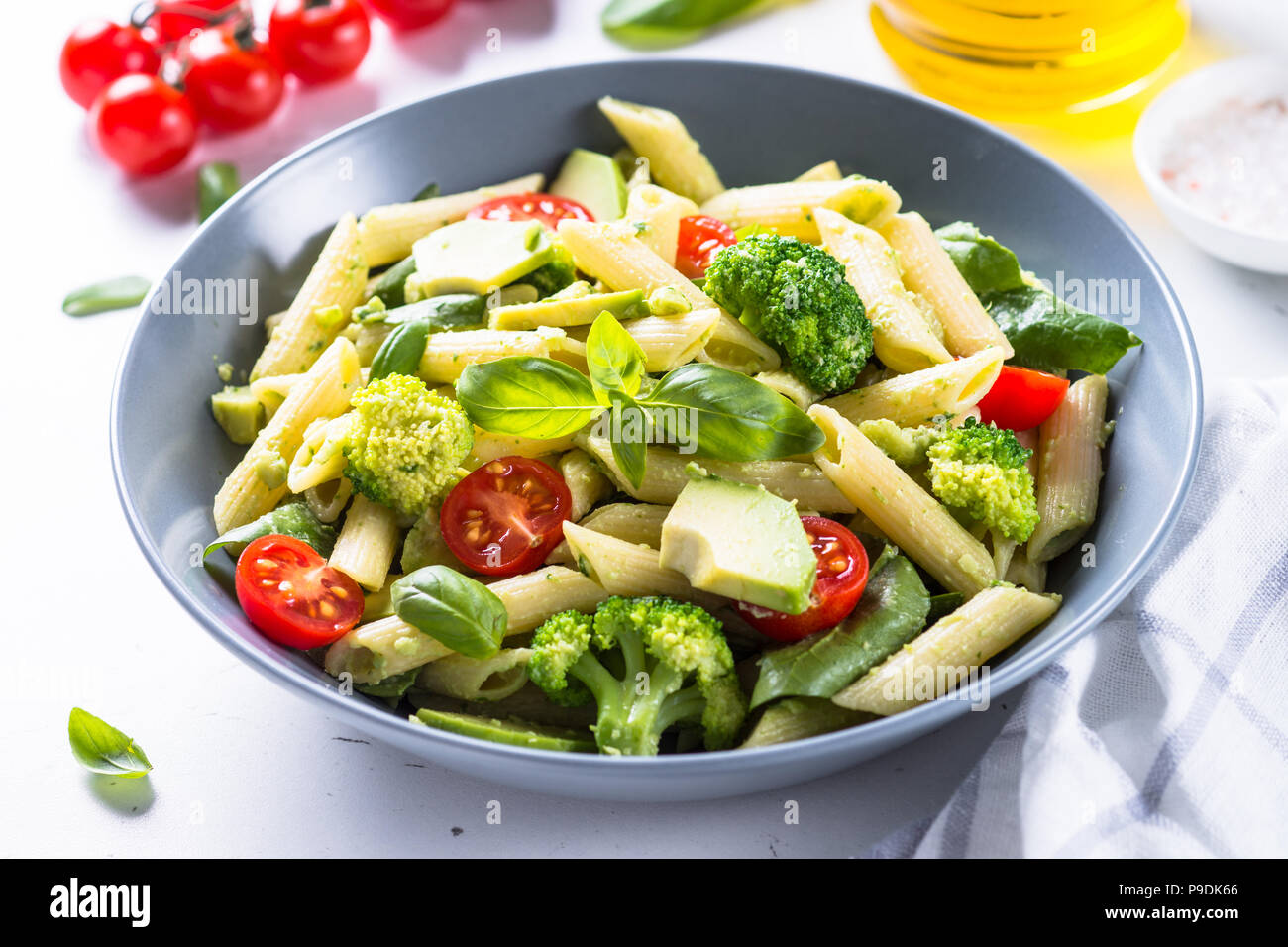 Vegetarian pasta penne with avocado, broccoli, tomato, spinach and