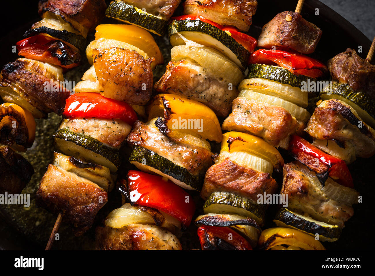 Grilled shish kebab or shashlik with vegetables  on skewers. Barbeque meat dish. Close up. Stock Photo