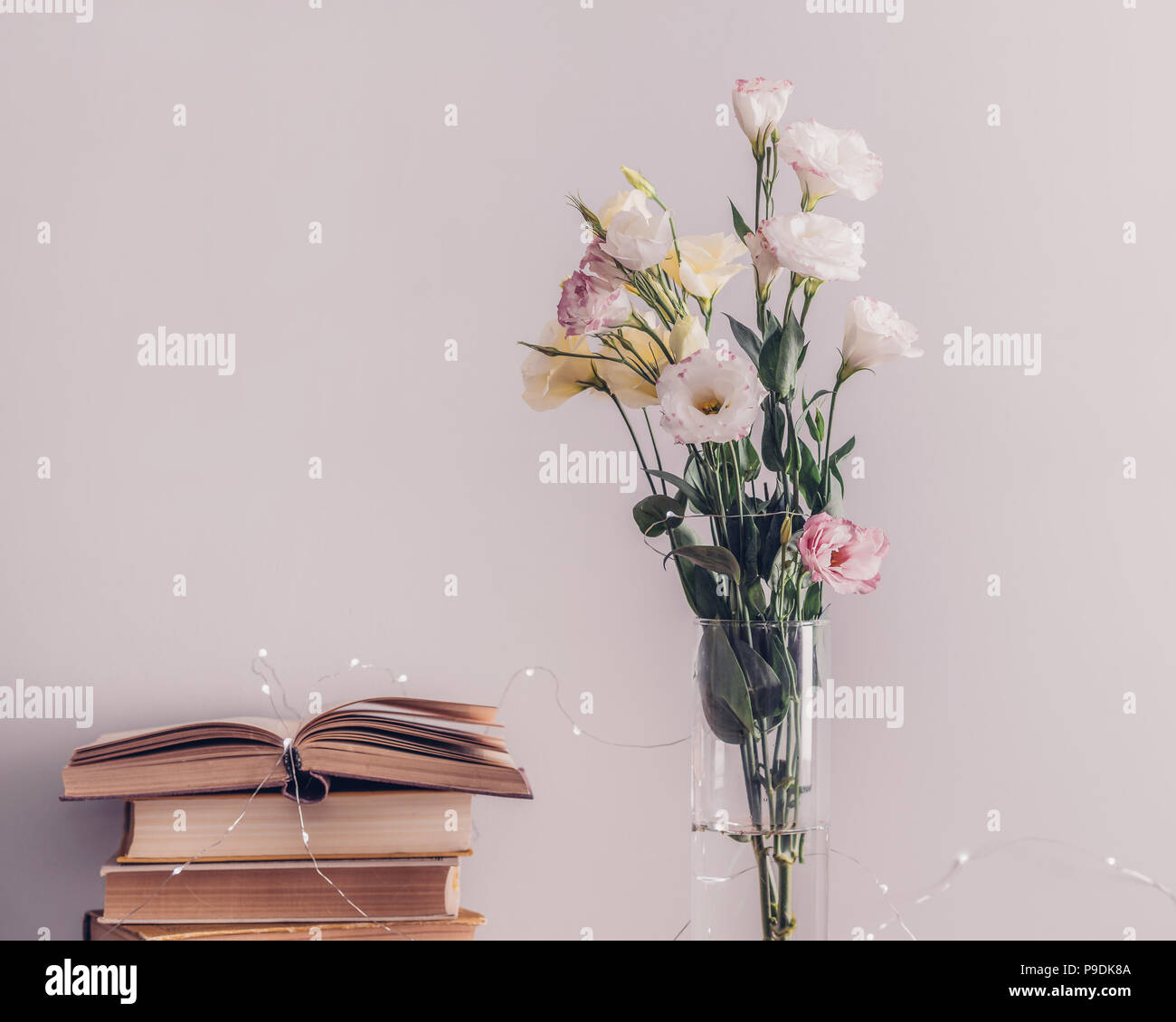 Eustoma Flowers Bouquet In A Vase Stack Of Old Vintage Books And