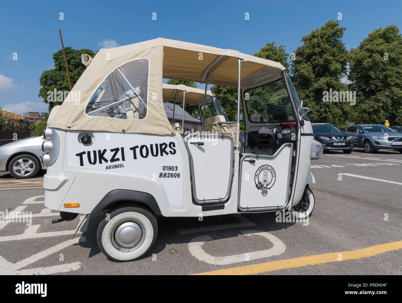 An empty white Piaggio Ape Calessino 3 wheeled cart (commonly known as a Tuk Tuk vehicle) from Tukzi Tours in Arundel, West Sussex, England, UK. Stock Photo