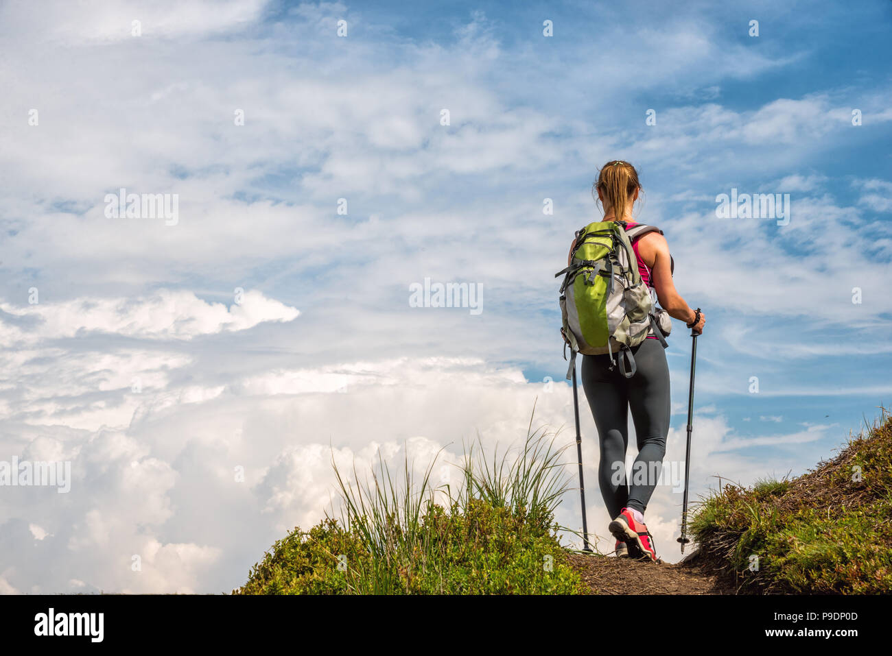 Young woman hiking in the mountains Stock Photo - Alamy