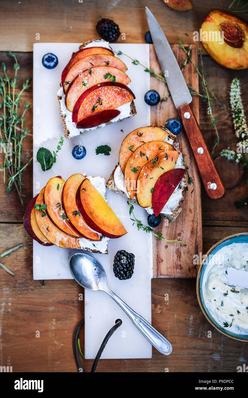 Fresh herbs goat cheese mousse and peaches crostini Stock Photo Alamy