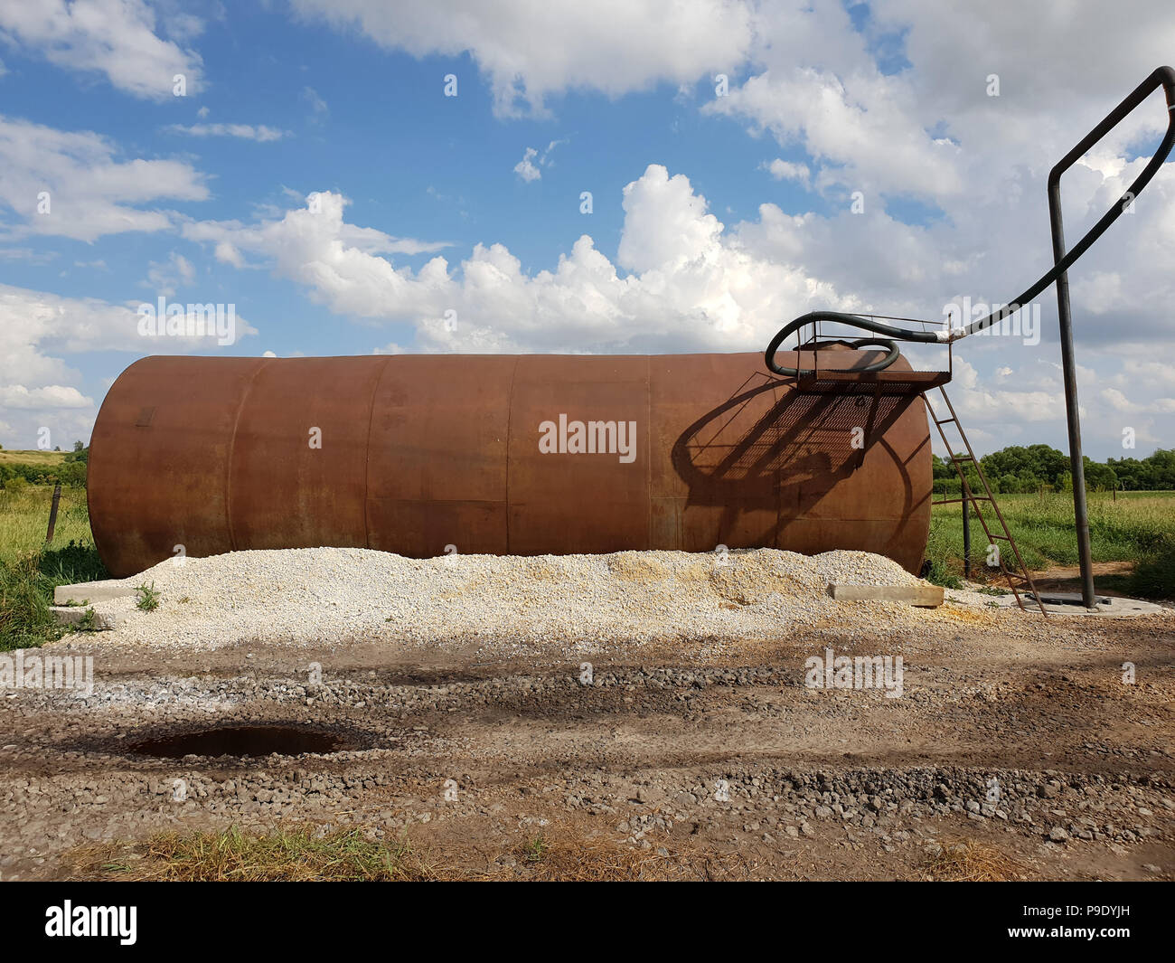 Tanks with liquid fertilizers on the outskirts of the field. Stock Photo