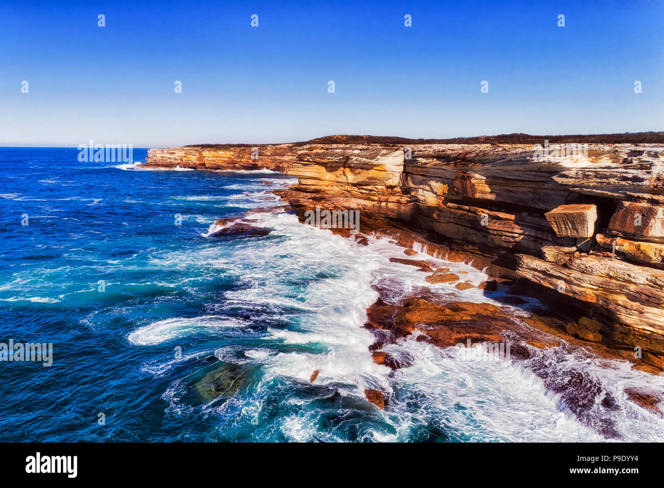 Bright sandstone cliffs of Cape Solander in Kamay Botany bay national park  of Sydney facing Pacific ocean waves which hit and erode australian contine  Stock Photo - Alamy