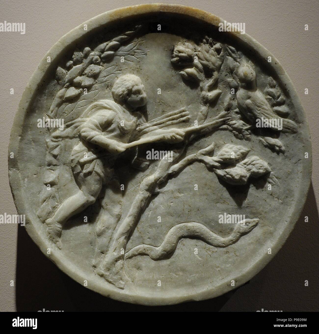 Oscillum with bird-catcher and head of Zeus Ammon in a corolla. Late 1st century BC. From Pompeii, House of Caecilius Iucundus V 1, 23-26. Marble. National Archeological Museum. Naples. Italy. Stock Photo