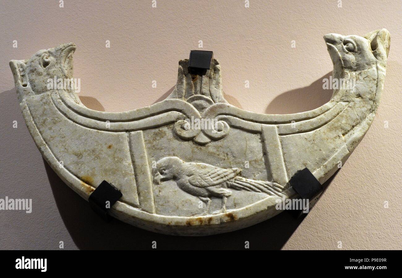 Oscillum shaped as a pelte with griphon-head terminations and with a ...