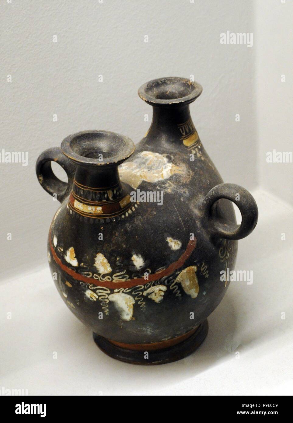 Small askos decorated with female head and vine shoot with leaves and tendrils. Made in Puglia. Second half of 4th century BC. National Archaeological Museum. Naples. Italy. Stock Photo