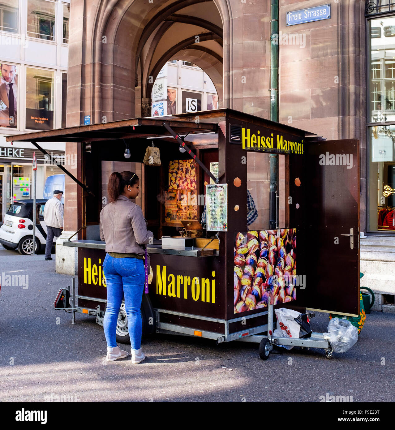 Basel, Heissi Marroni stall, woman buying roast chestnuts, Switzerland, Europe, Stock Photo