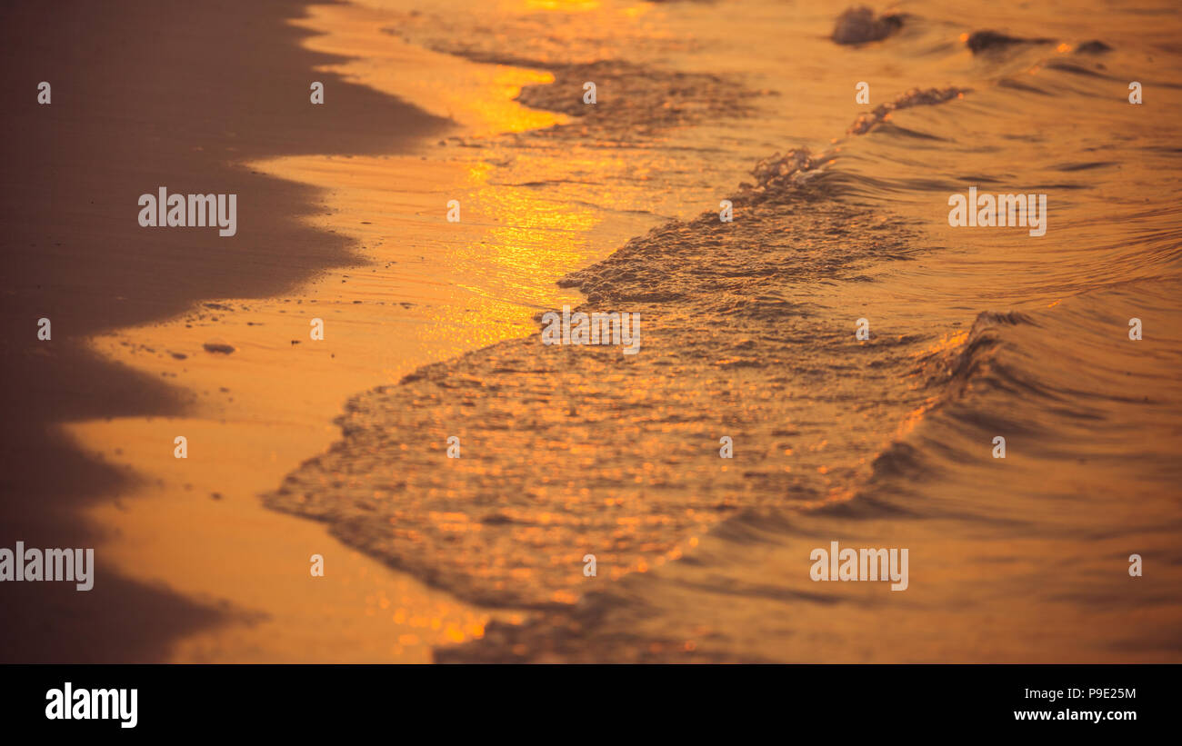 Soft waves splashing on tropical coastline Stock Photo