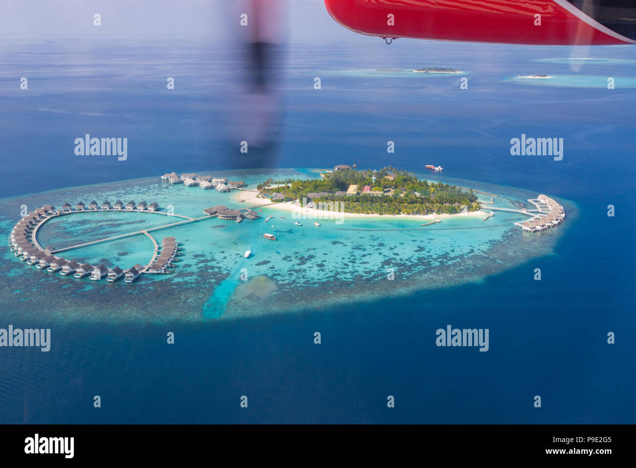 Beautiful aerial image of Maldives islands and luxury tropical resorts from seaplane. Aerial view of tropical sea and island Stock Photo