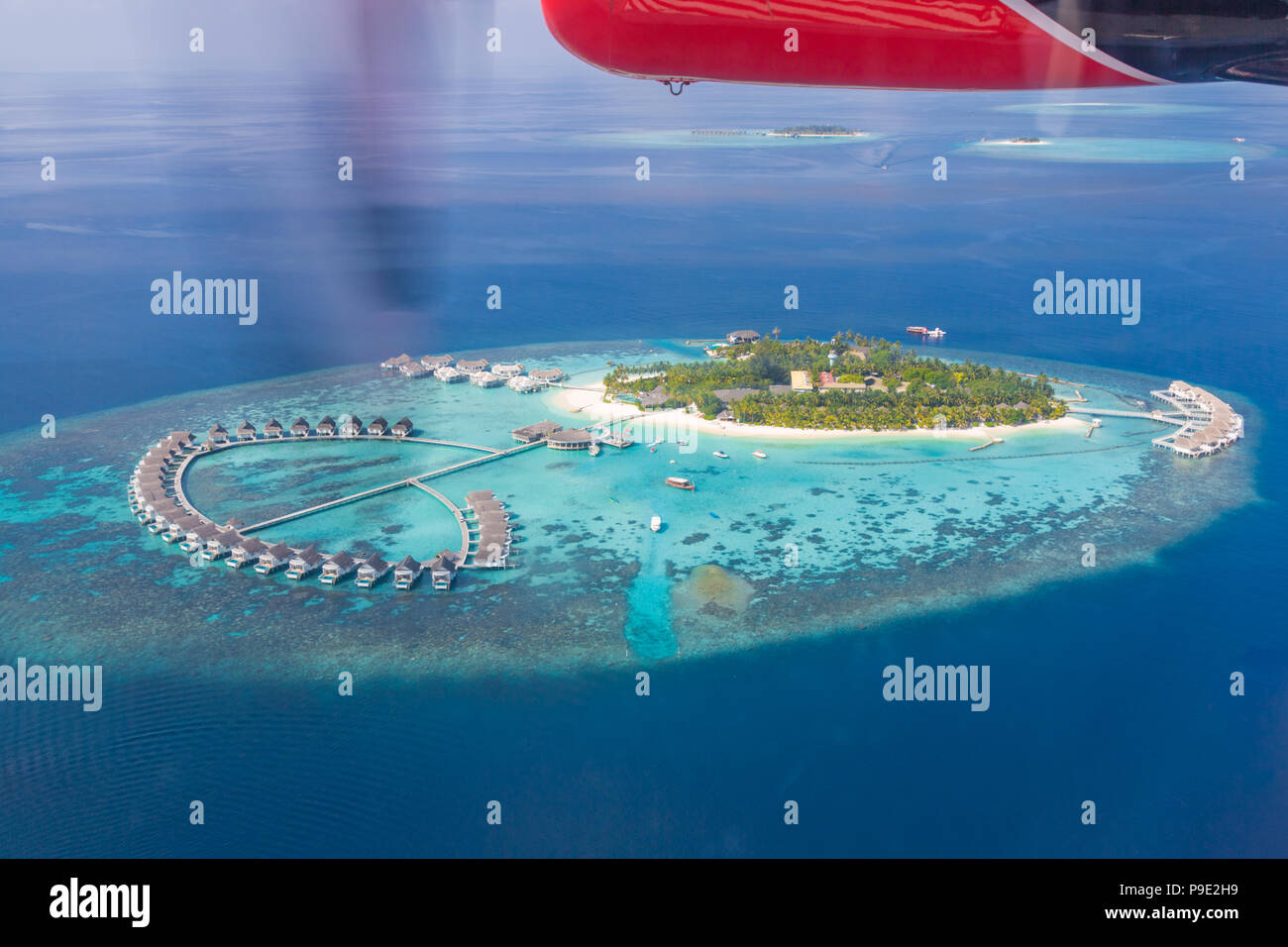 Beautiful aerial image of Maldives islands and luxury tropical resorts from seaplane. Aerial view of tropical sea and island Stock Photo