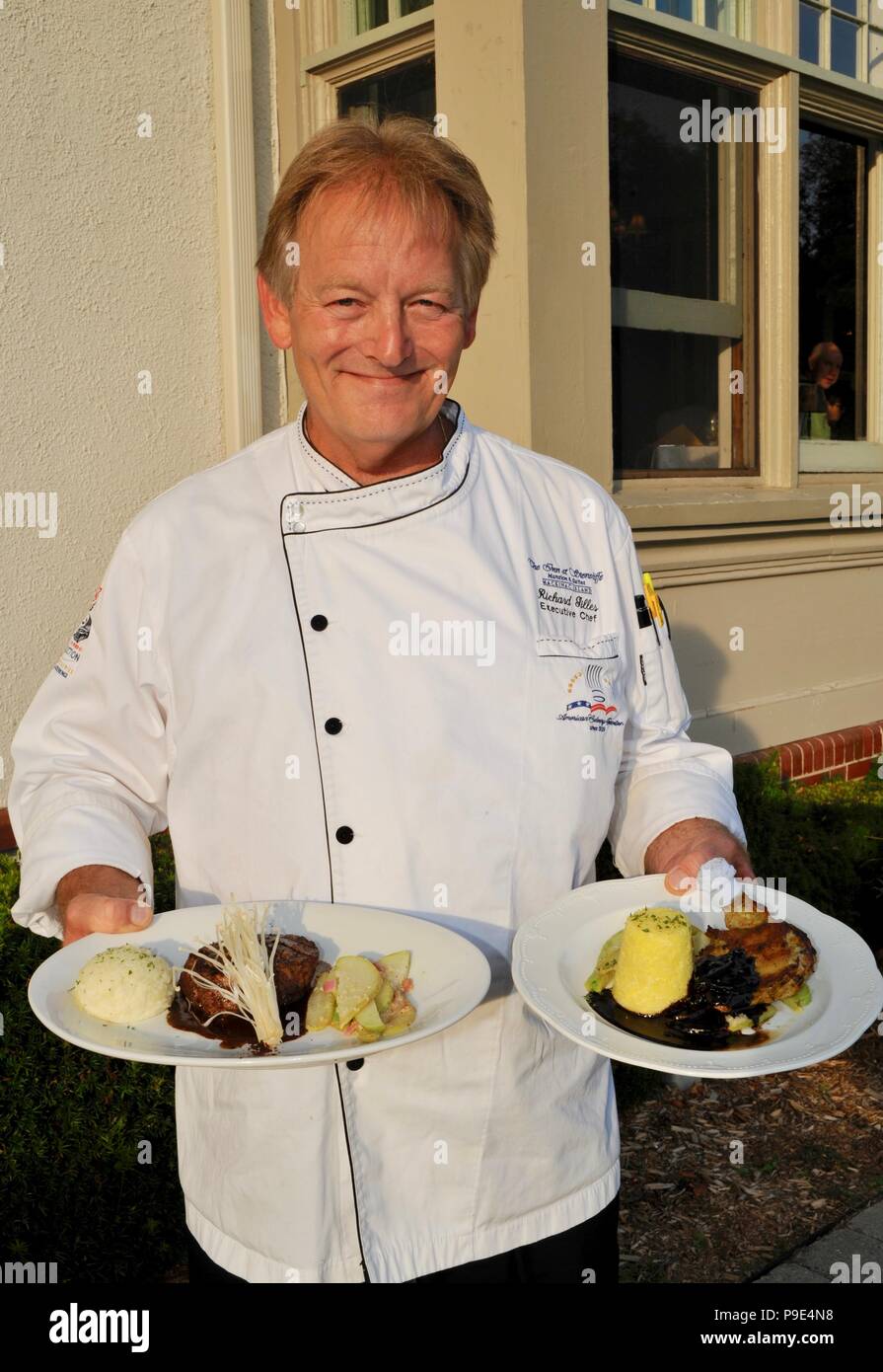 Executive Chef holding plated entrees to be served at The Cudahy Chophouse Restaurant at The Inn at Stonecliffe, Mackinac Island, Michigan, USA Stock Photo