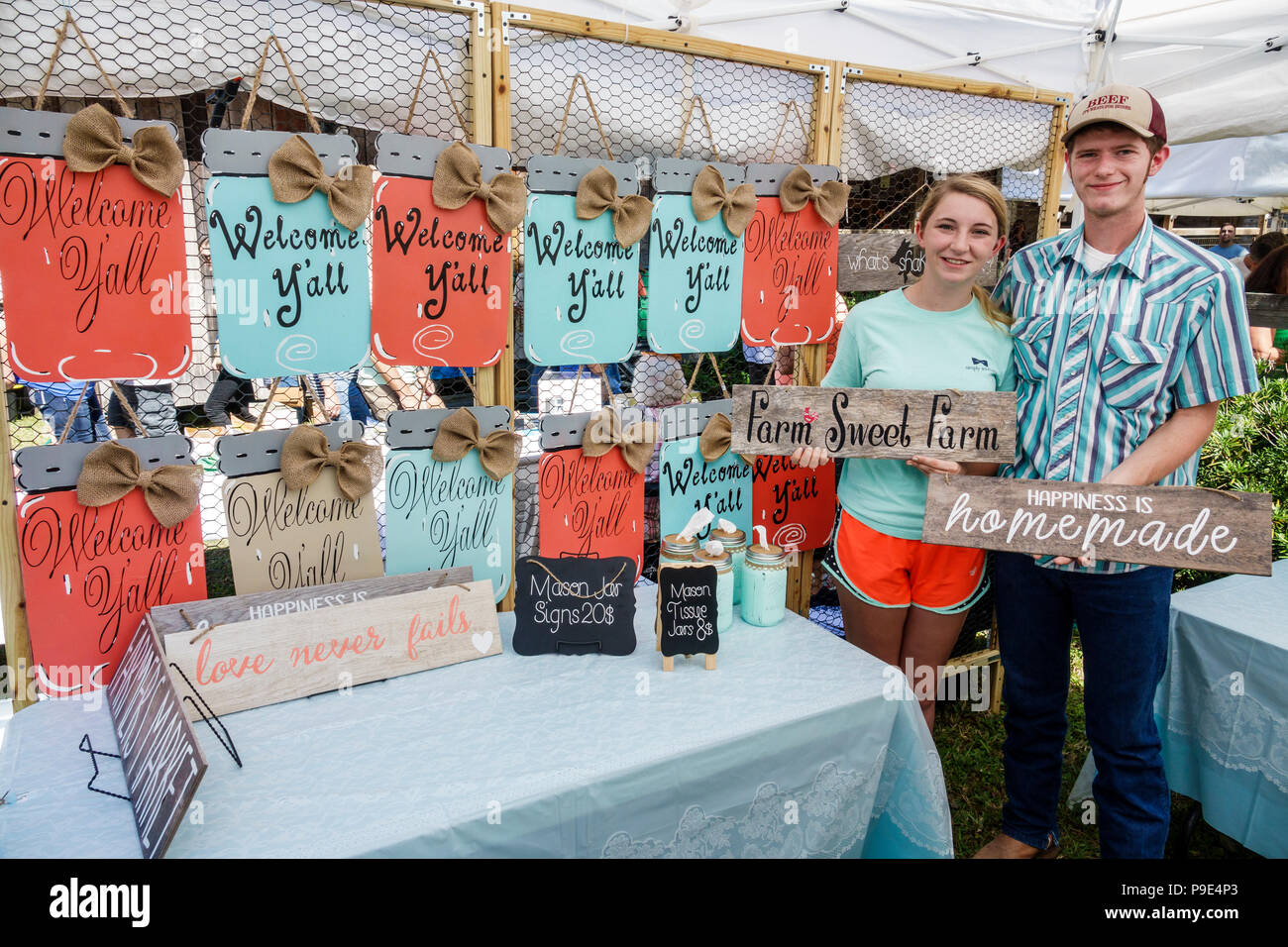 Florida,Micanopy,Fall Harvest Festival,annual small town community booths stalls vendors buying selling,handicraft,hand painted signs,boy boys,male ki Stock Photo