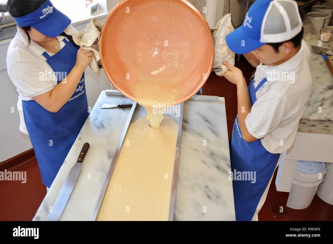 World famous fudge making, pouring the hot fudge from copper kettle, at