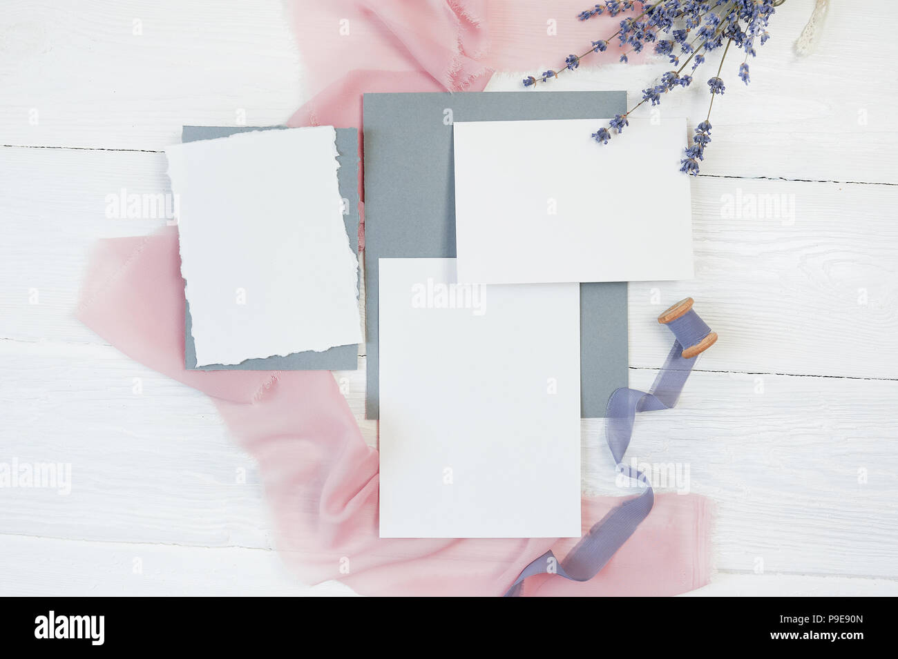White blank card ribbon on a background of pink and blue fabric with ...