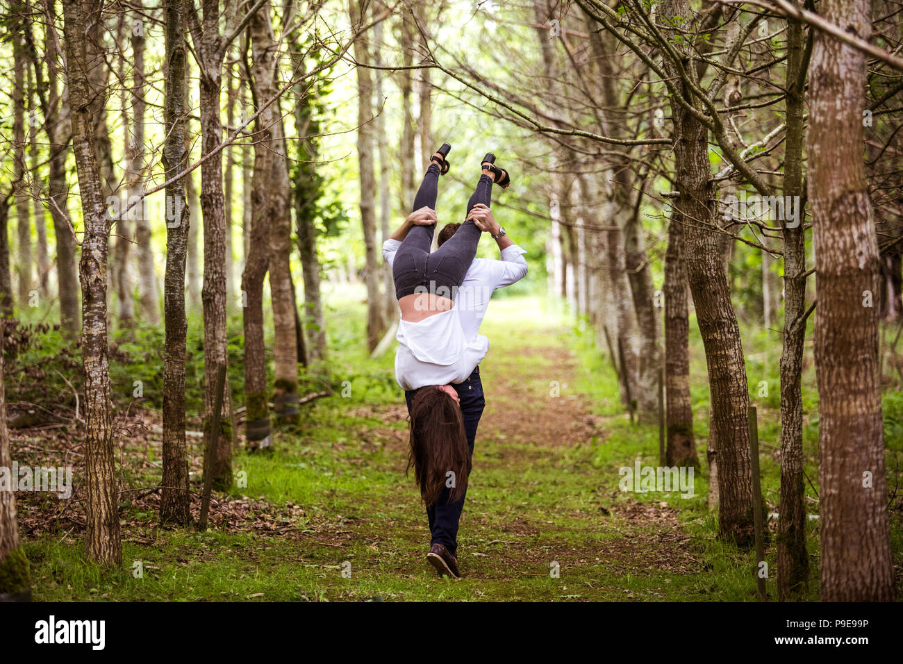 Man carrying woman over shoulder hires stock photography and images