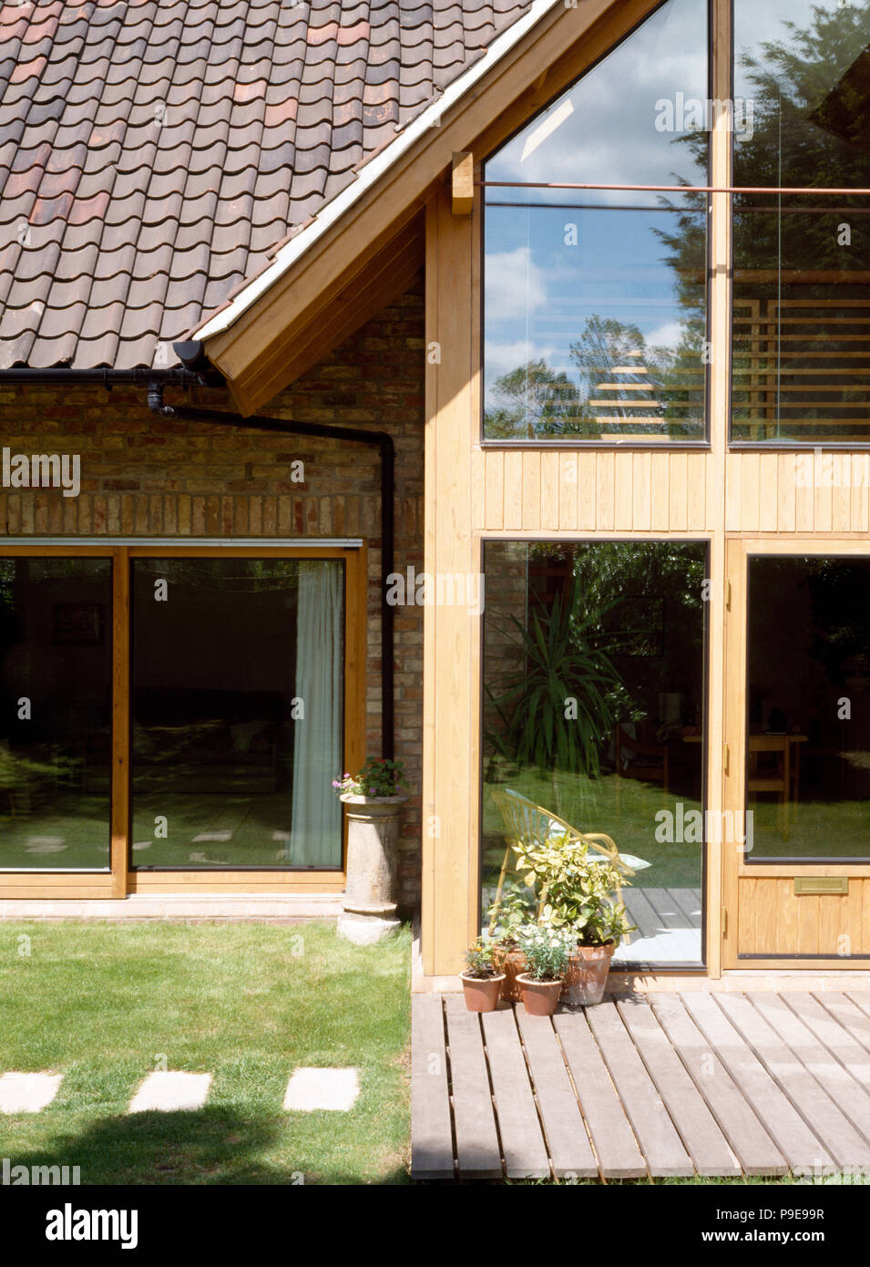 Exterior of modern country house with wooden decking and large windows