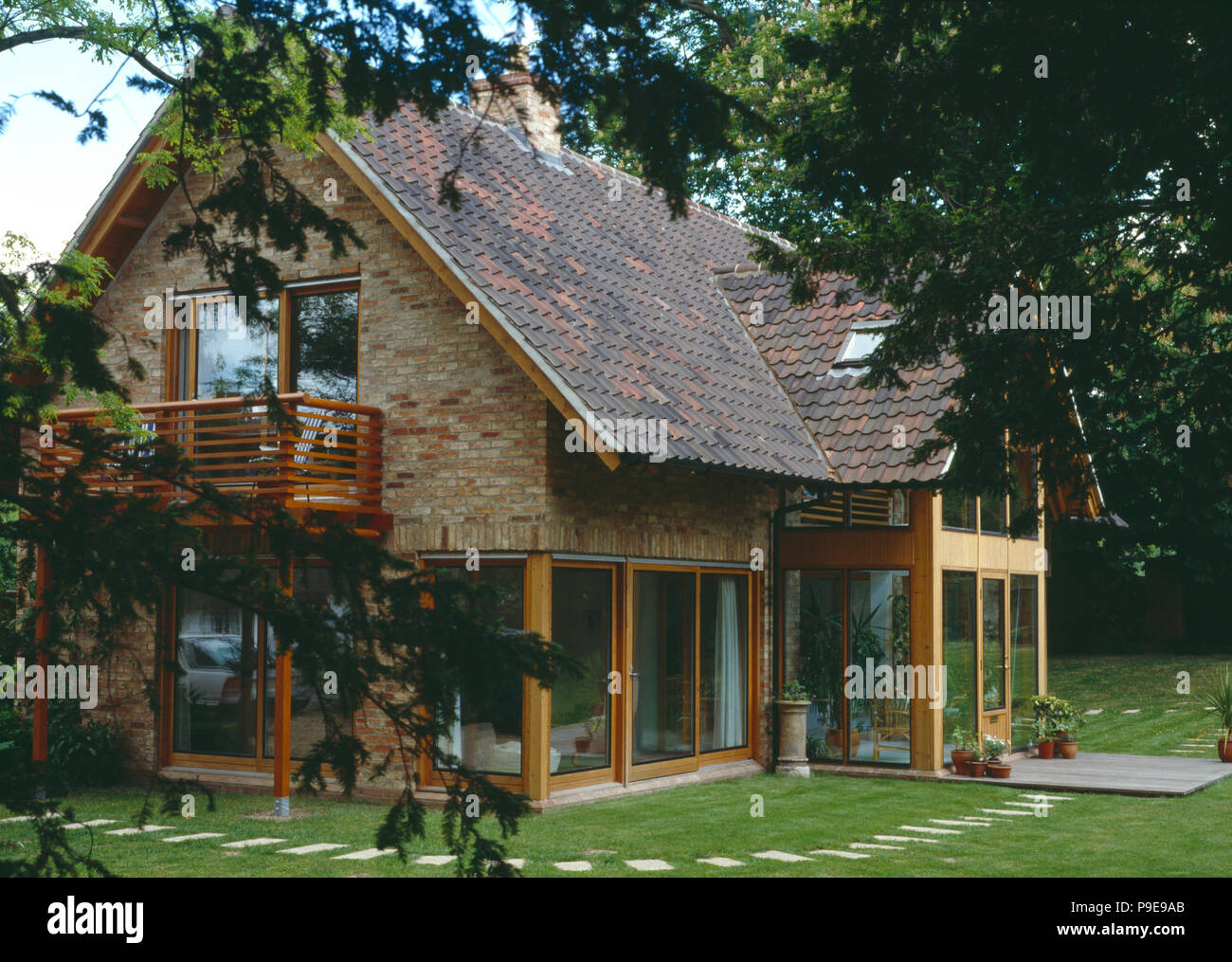 Modern country house with reclaimed roof pantiles and wooden balcony Stock Photo