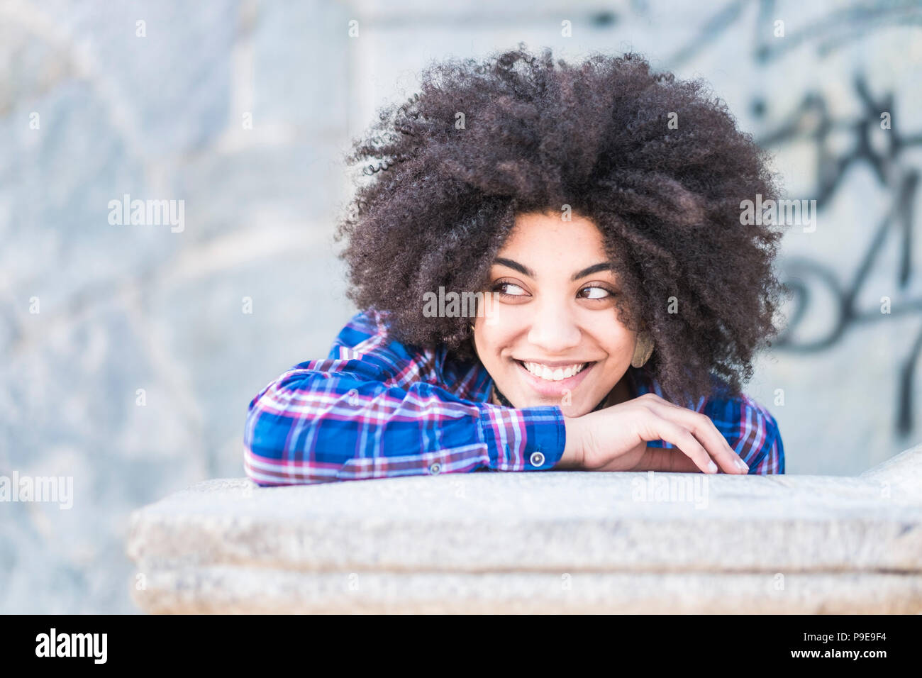 portrait of black skin african race of beautiful young girl smiling and looking at her side. enjoying the time and the leisure activity. casual and fa Stock Photo