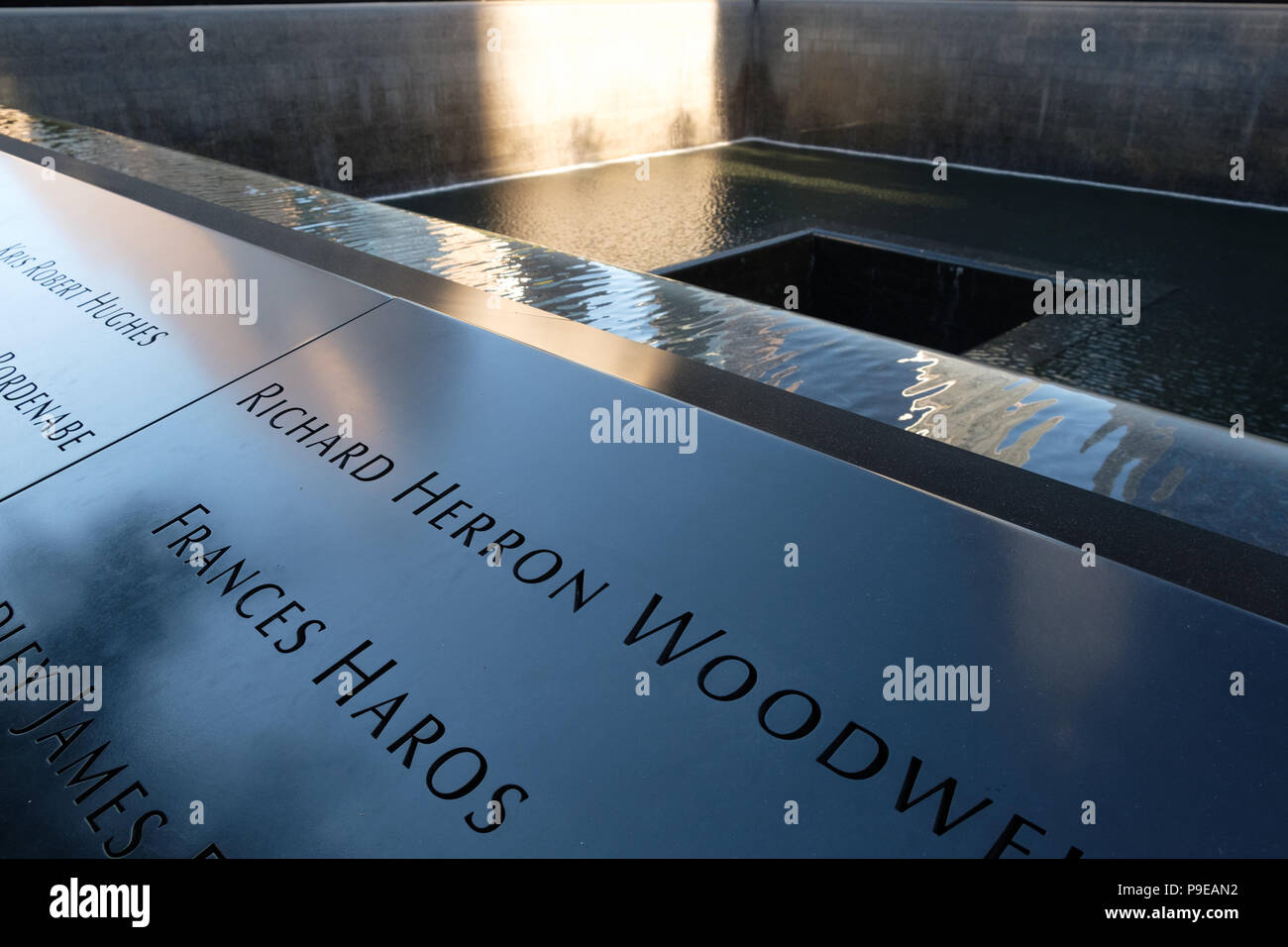 The names of people who died in the terrorist attacks of September 11, 2001 inscribed in bronze around the twin memorial Stock Photo