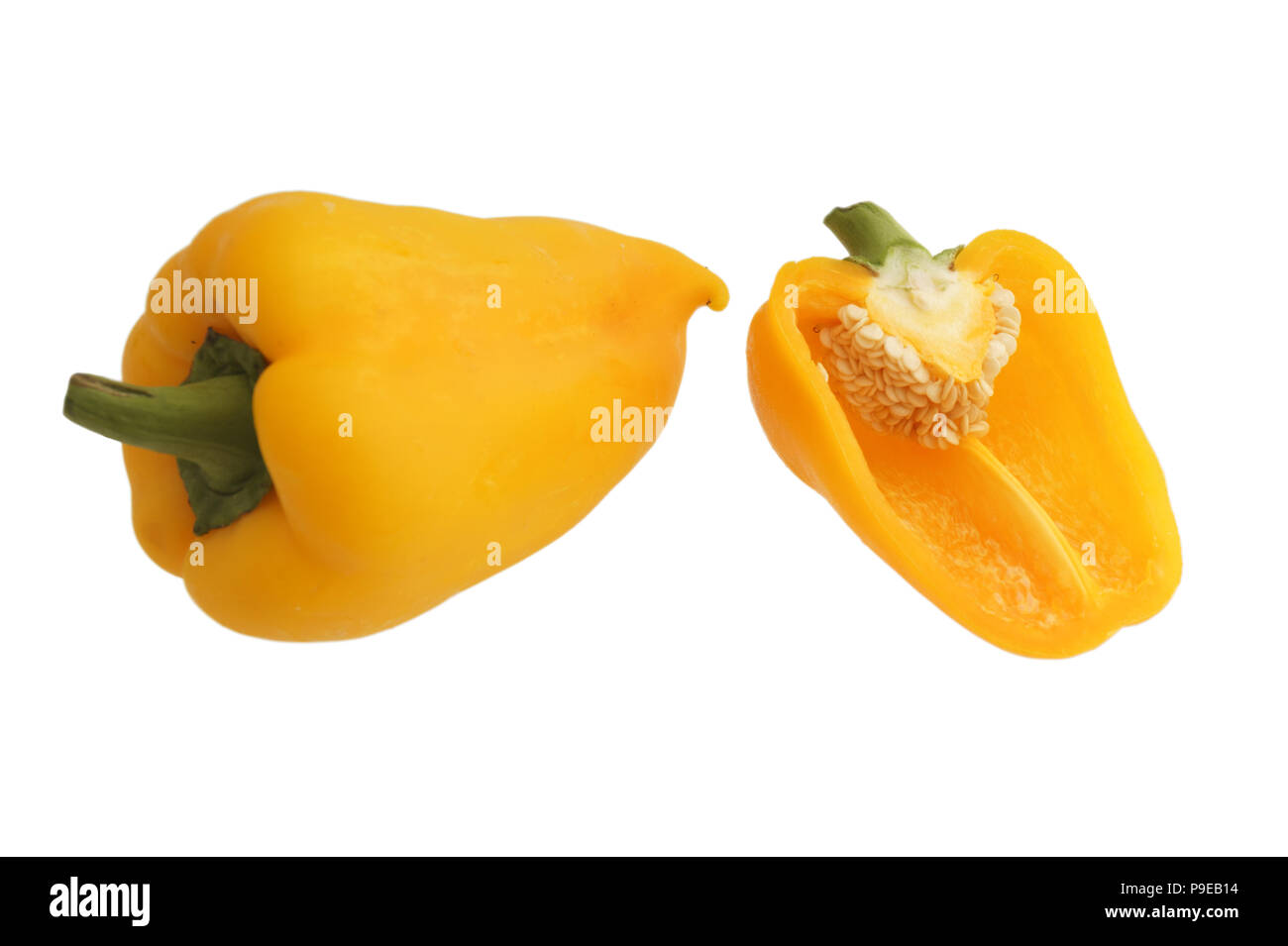 one whole yellow bell pepper and half with seeds  isolated on white background close up Stock Photo