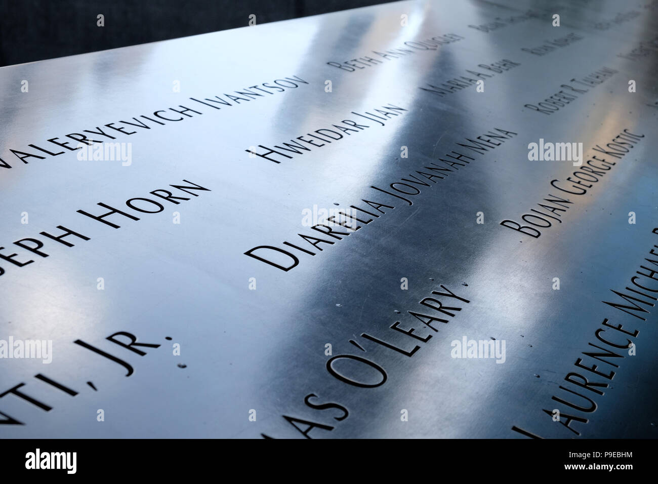 The names of people who died in the terrorist attacks of September 11, 2001 inscribed in bronze around the twin memorial Stock Photo