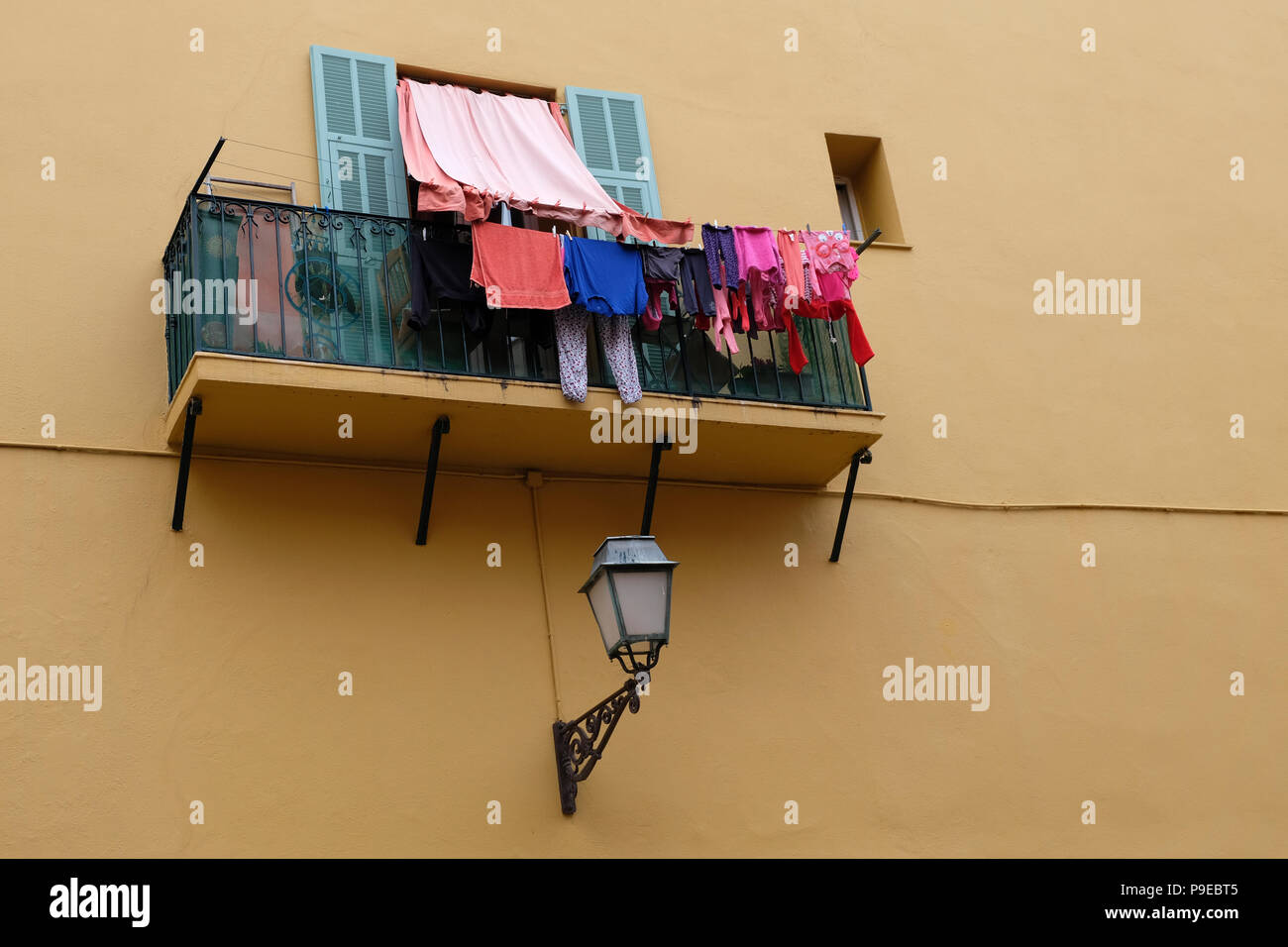 Nice, France. Colourful washing hanging from apartment balcony in the Old Town area of Nice Stock Photo