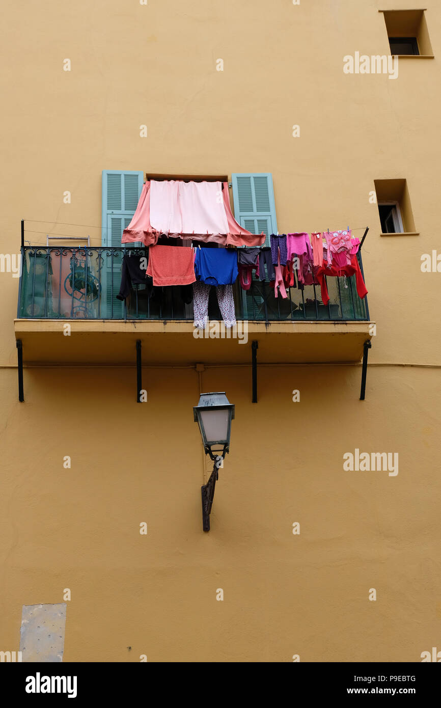 Nice, France. Colourful washing hanging from apartment balcony in the Old Town area of Nice Stock Photo