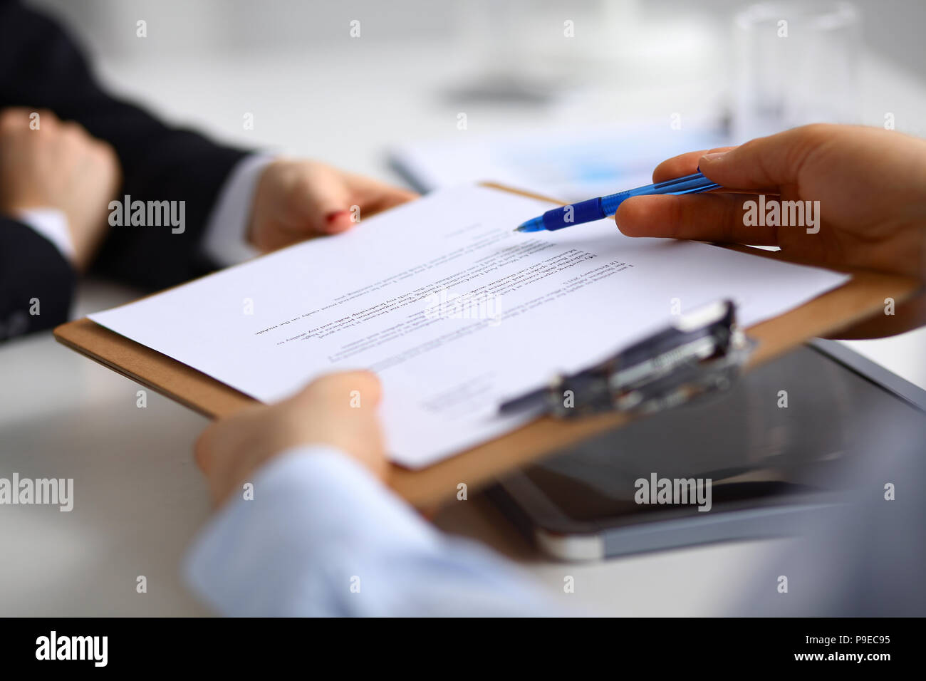 Businesspeople sitting on the desk on office Stock Photo