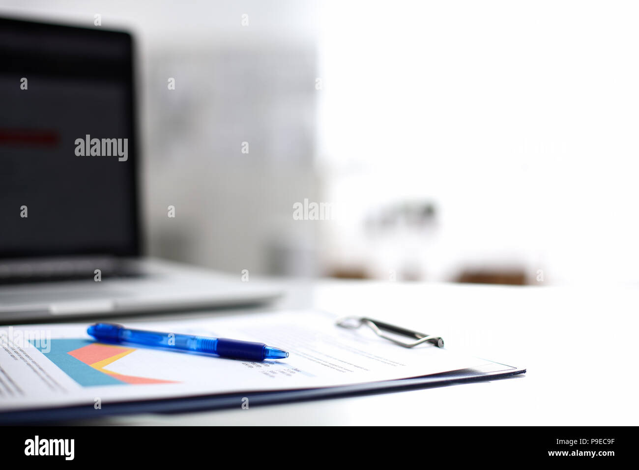 Laptop  computer with folder on  desk  Stock Photo