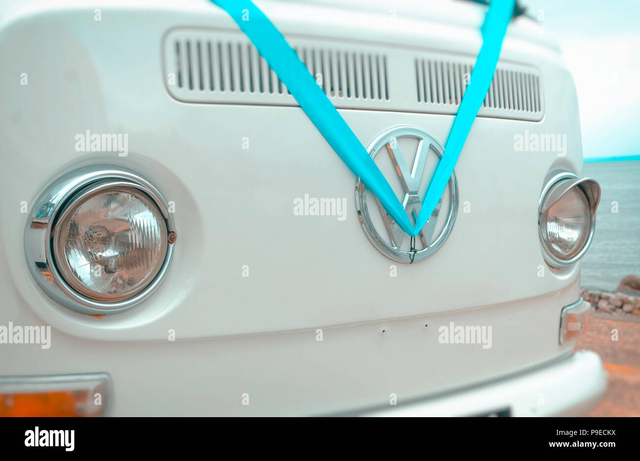 Volkswagen VW Badge on a camper van dressed in a blue wedding ribbon. Stock Photo