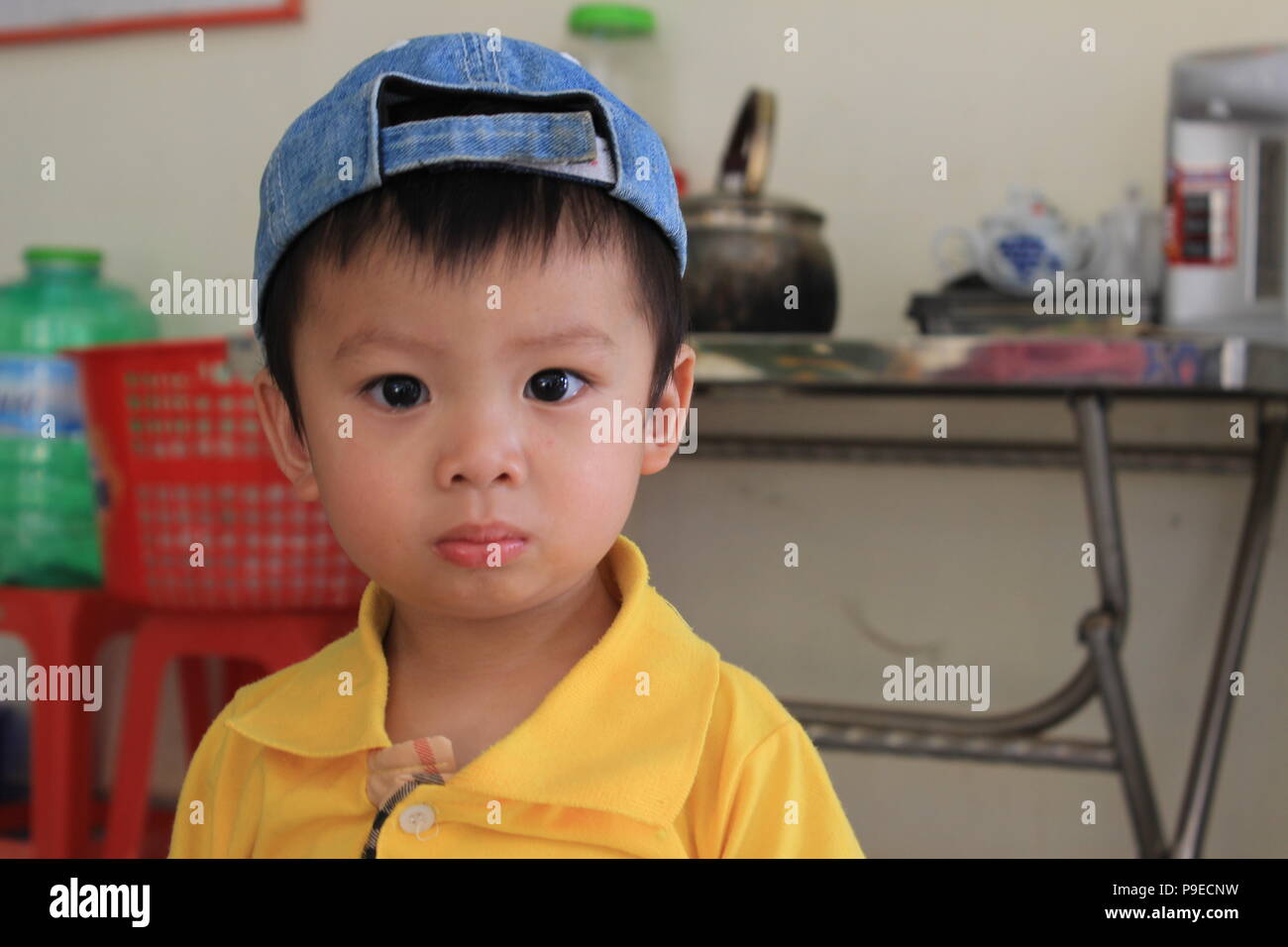 Kid wearing a baseball cap in Da Lat, Vietnam Stock Photo