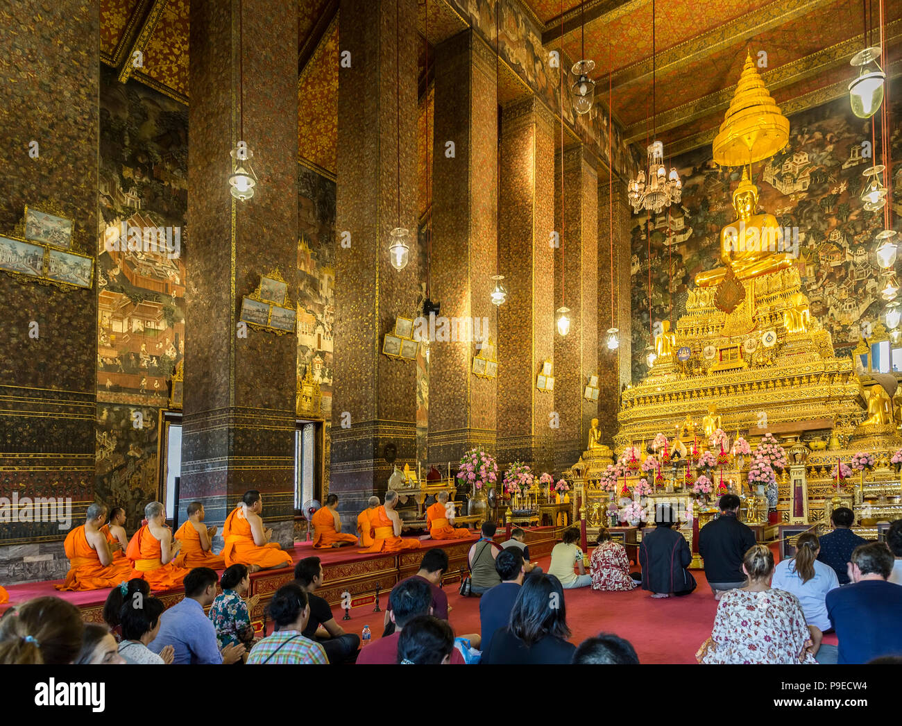 People and monks praying, Wat Pho temple, Bangkok, Thailand Stock Photo