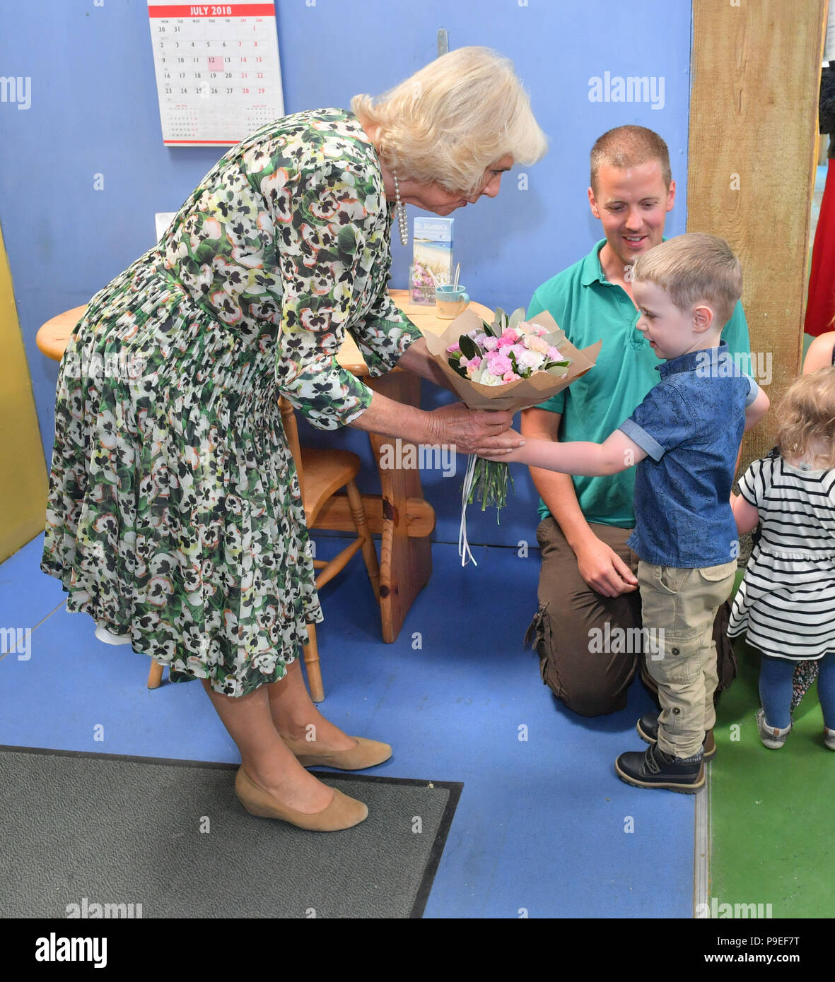 The Duchess of Cornwall is presented with flowers by four-year-old Jowan Haggerty as she visits Scilly Flowers during a visit to St Martin's, one of the Scilly Isles. Stock Photo