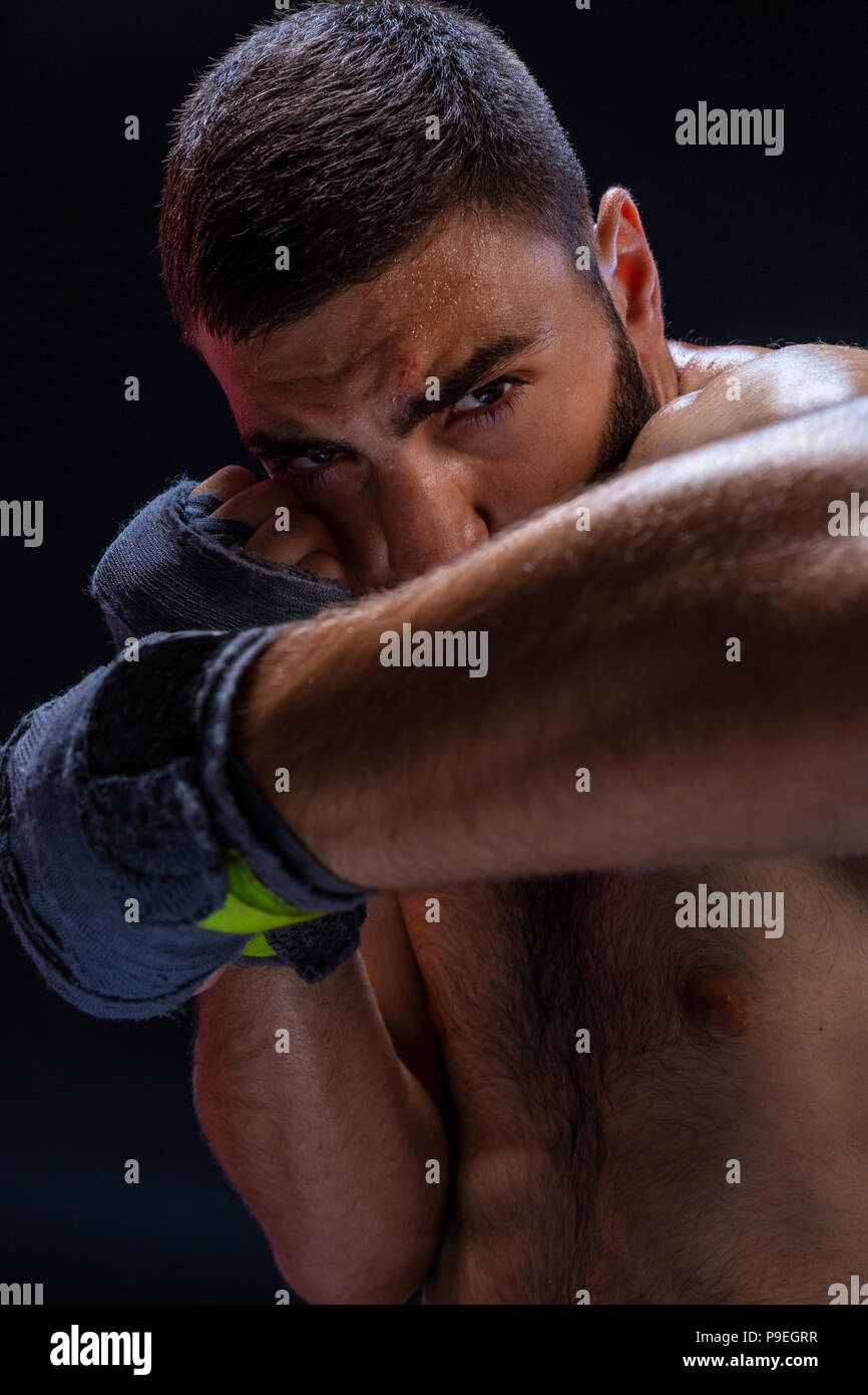 Double arm block. Boxing trainer showing defensive techniques. Combat sport, fight club Stock