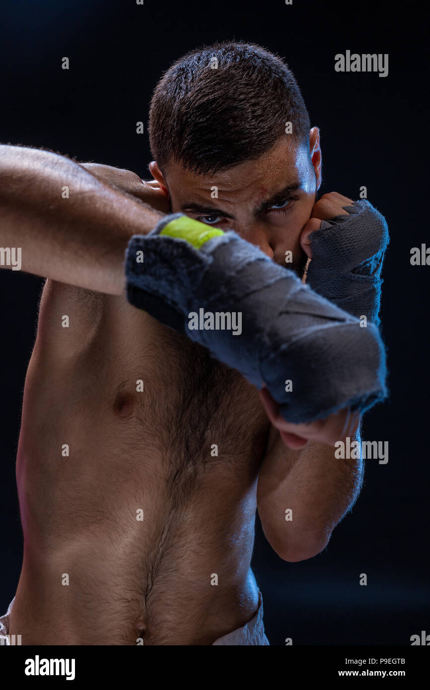 Double arm block. Boxing trainer showing defensive techniques. Combat sport, fight club. Stock Photo