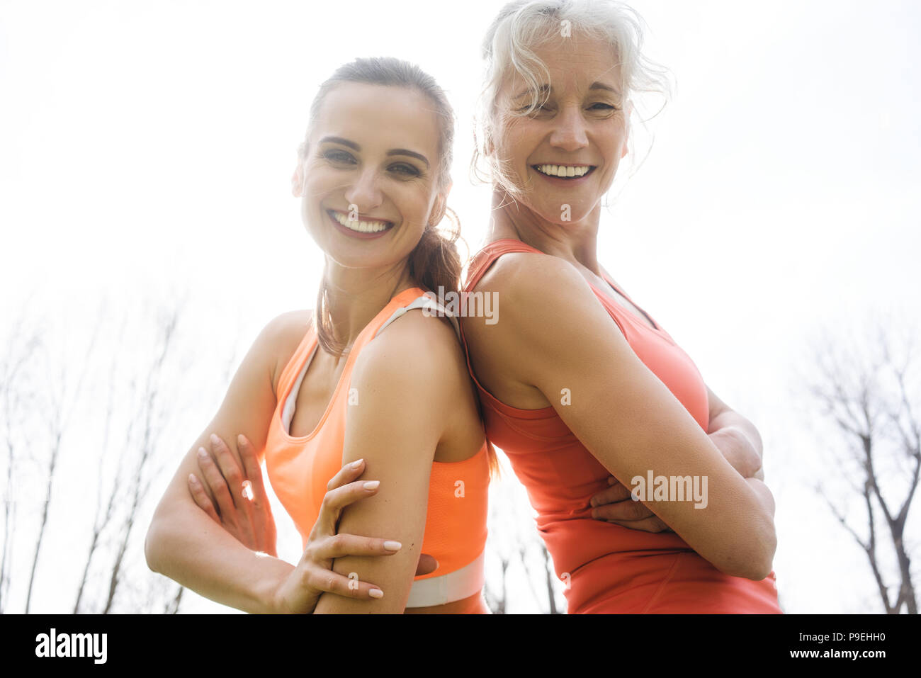 Senior and young woman doing sport outdoors Stock Photo