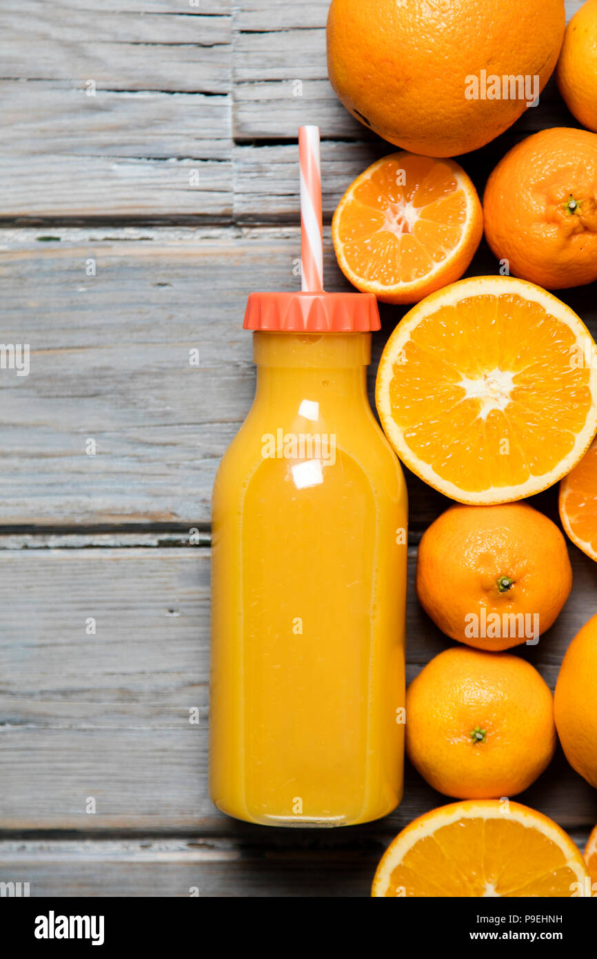 Fresh orange juice in a bottle with oranges on a rustic wooden background  Stock Photo - Alamy