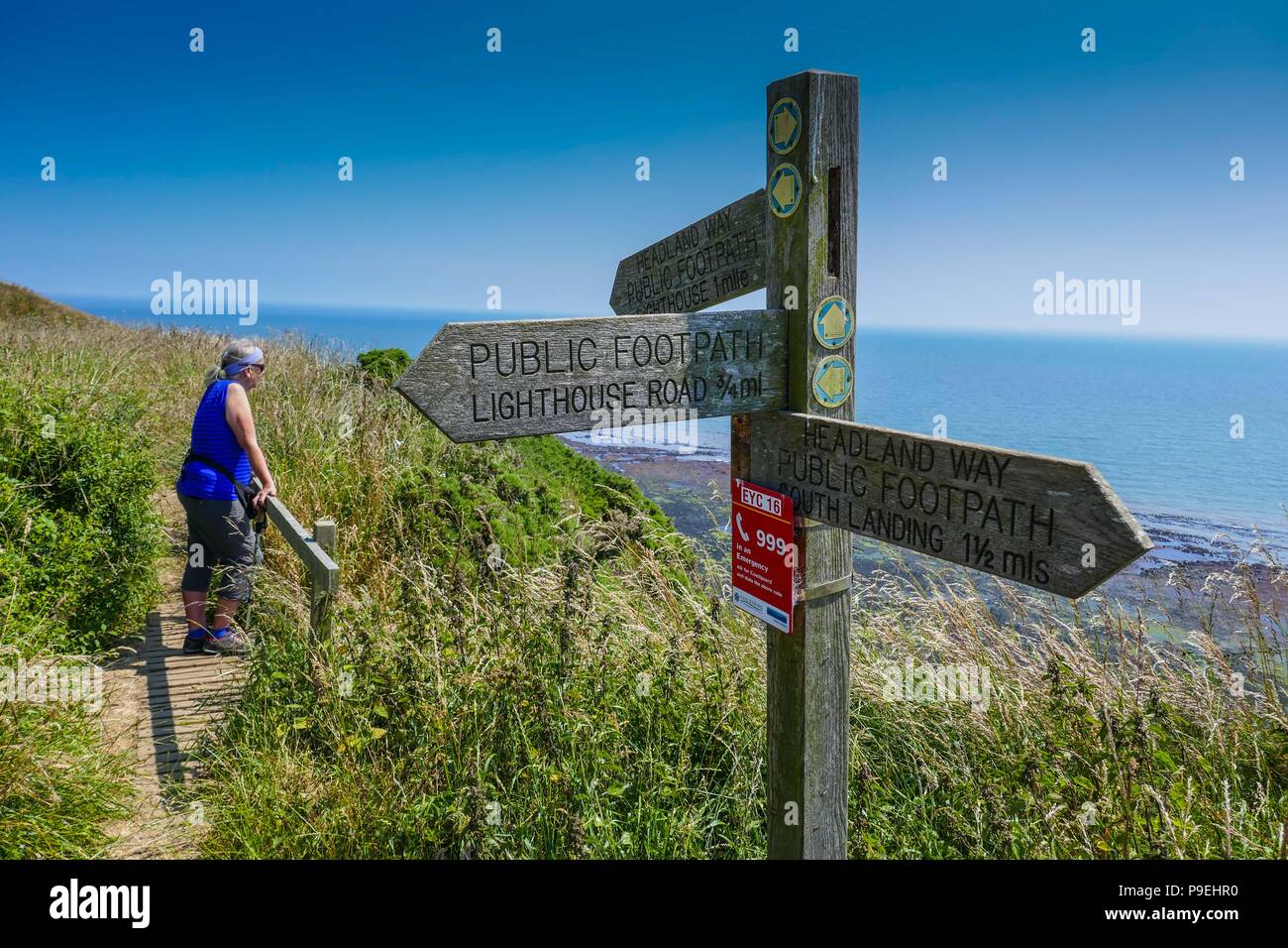Walker with footpath sign and Summer weather at Flamborough Head, Easy Yorkshire Stock Photo