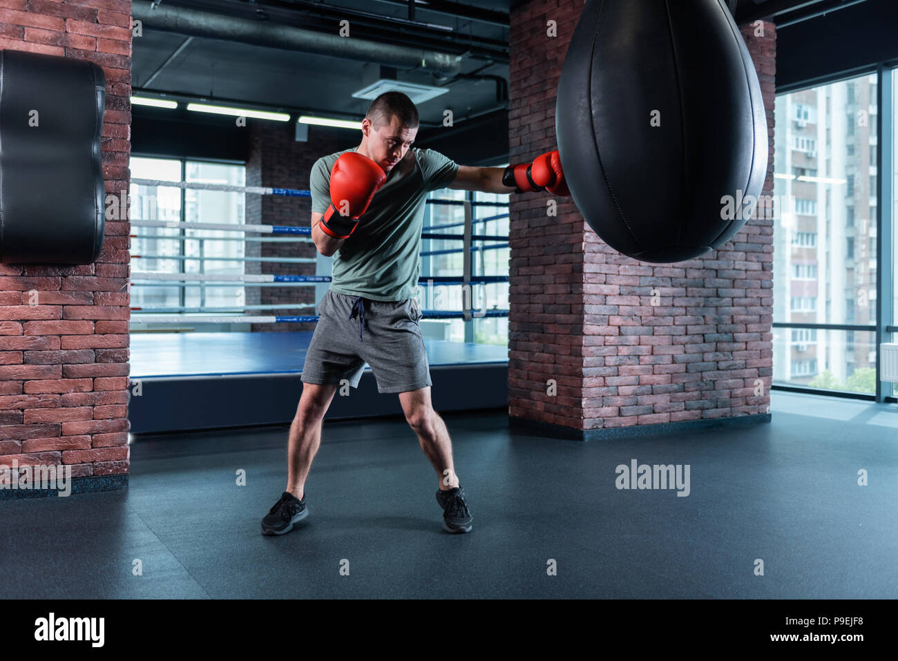 Strong athlete boxing hard wearing red gloves Stock Photo Alamy