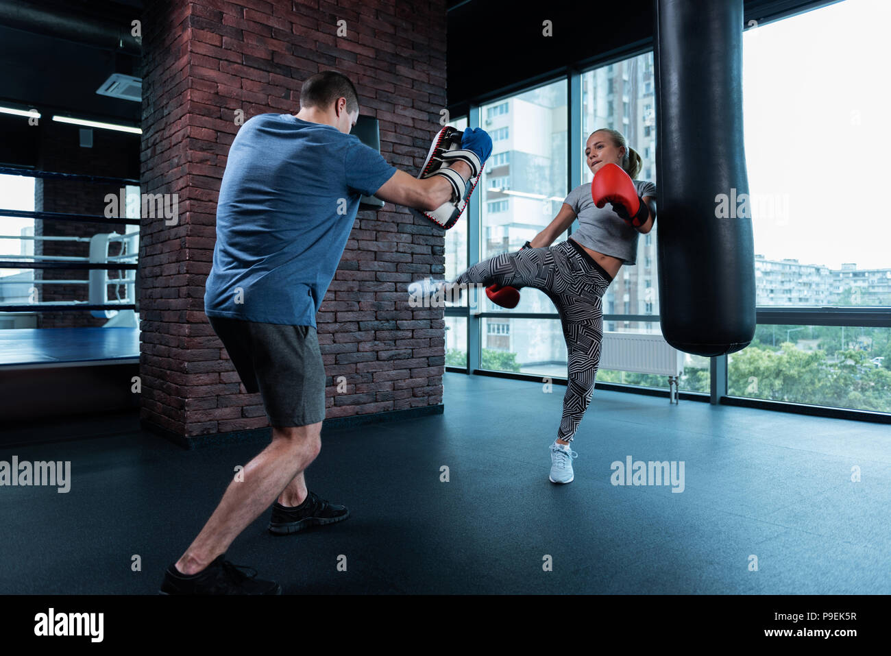 Athletic blonde-haired woman having no stress while boxing Stock Photo