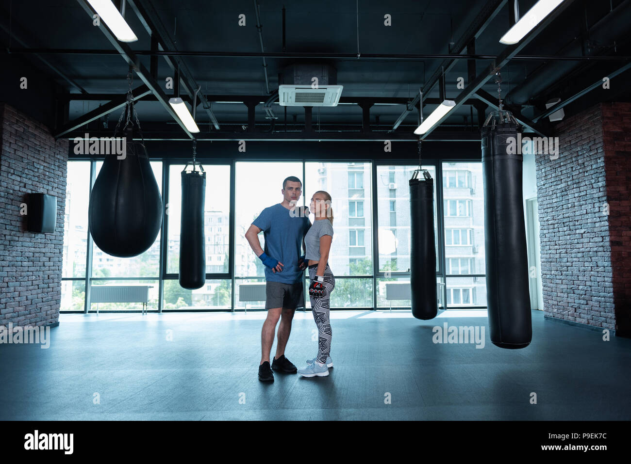 Young appealing athletic couple training together in gym Stock Photo ...