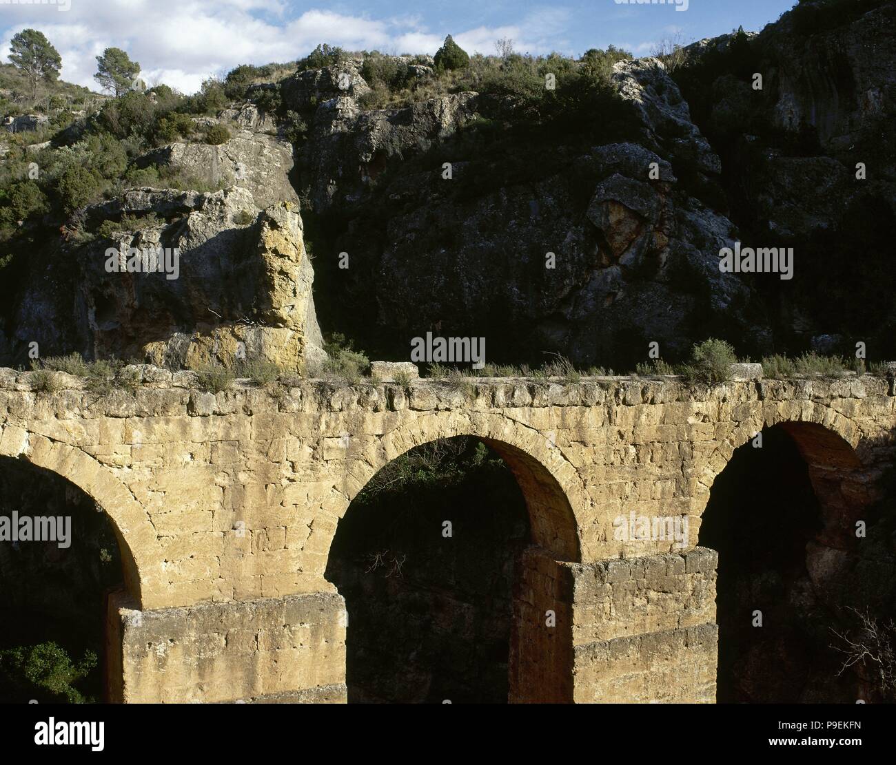 Roman Aqueduct of Peña Cortada. 1st century A.D. Also known as Acueducto de La Serrada or La Serranía. View of one of the sections that are still preserved, located between the towns of Chelva and Calles. Province of Valencia. Valencian Community. Spain. Stock Photo
