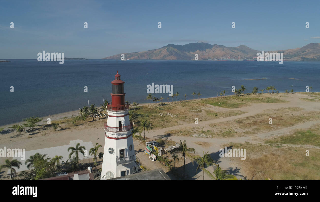 Coastline with beach and lighthouse, mountains. Aerial view: Coast sea with hotels, resorts, Subic Bay, Philippines, Luzon Stock Photo