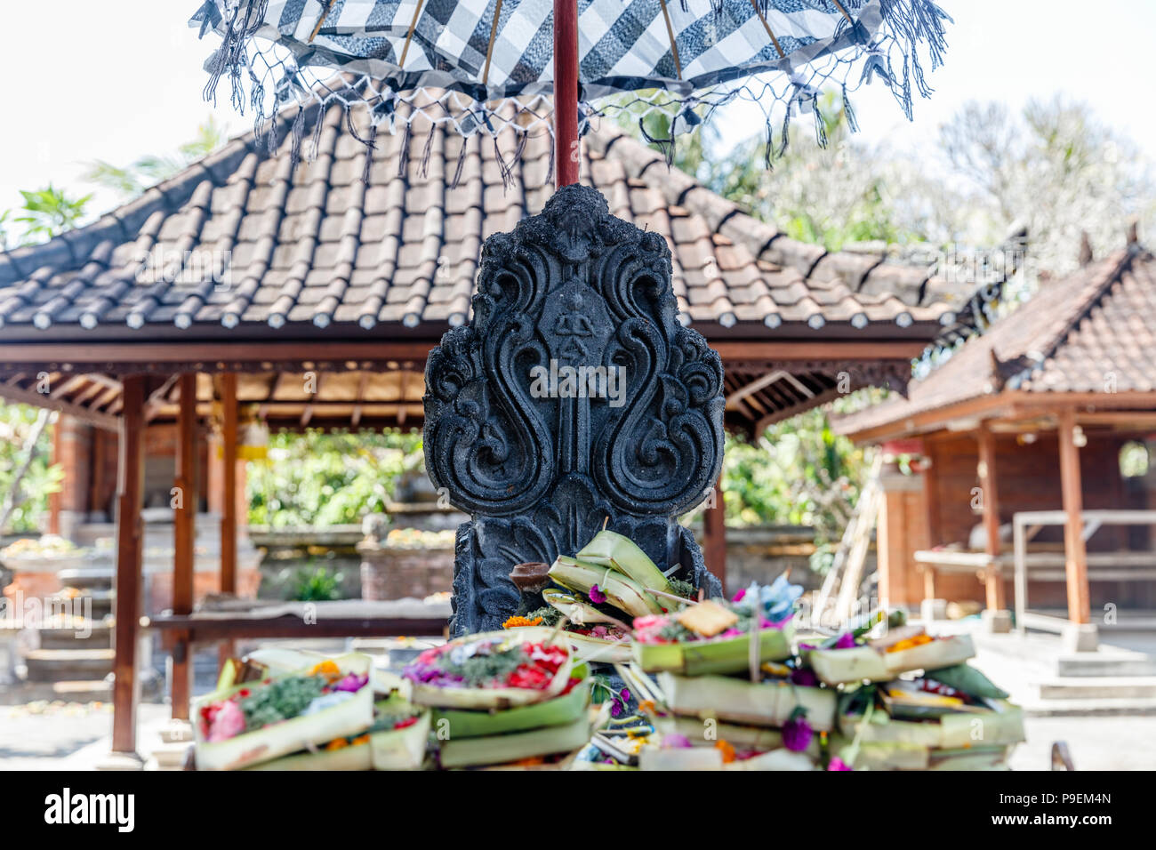 Balinese offerings (canang sari) on altar at Hindu temple in Sanur. Bali, Indonesia. Stock Photo