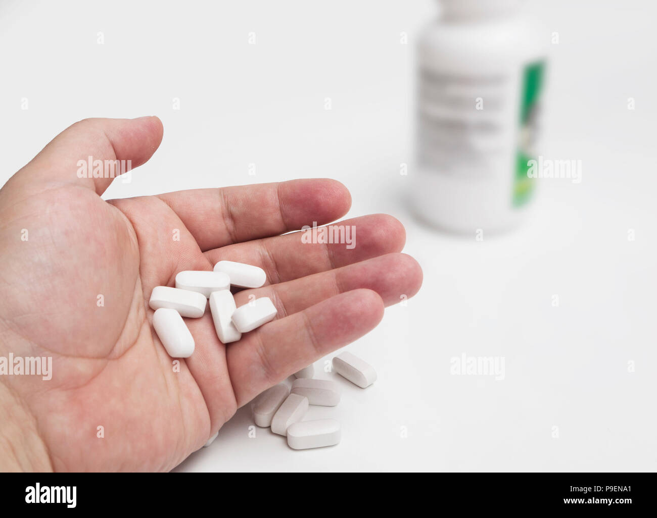 White pills and medicines in the hand Stock Photo